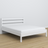 Double bed white – wooden headboard, close-up of wood quality